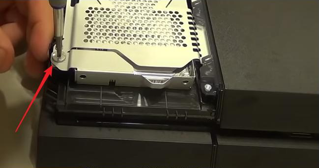 Remove the ps4 screw with a screwdriver